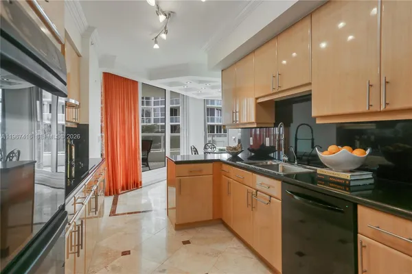 a kitchen with stainless steel appliances granite countertop a sink and cabinets