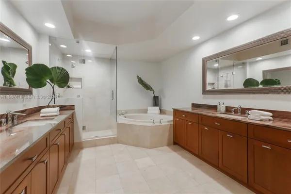 a large kitchen with a sink and large stainless steel appliances