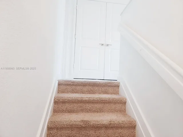 a bathroom with a granite countertop toilet and a sink