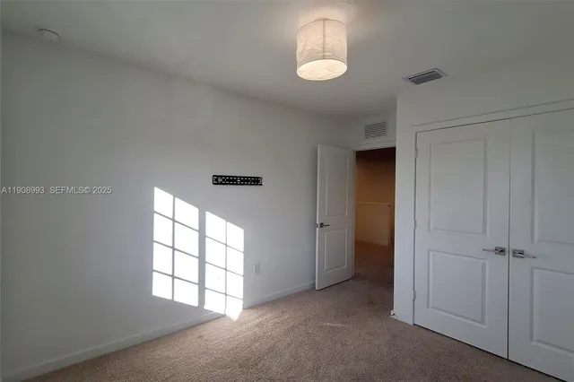 a kitchen with stainless steel appliances a refrigerator and a stove top oven