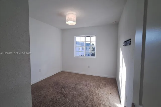 an empty room with windows and natural light