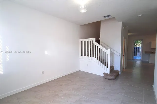a kitchen with granite countertop a stove and cabinets