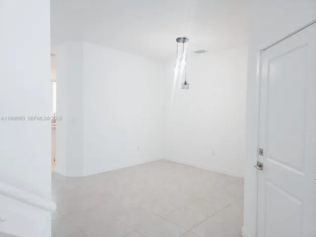 a view of staircase with white walls