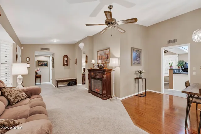 a living room with furniture and a kitchen
