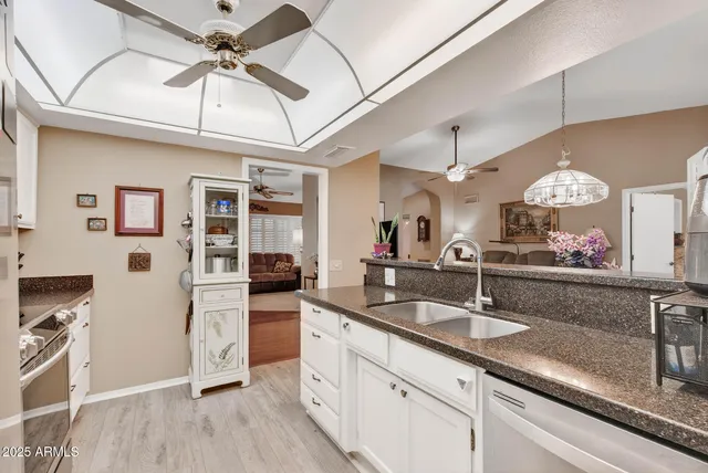 a very nice looking kitchen with granite countertop a sink stainless steel appliances and cabinets
