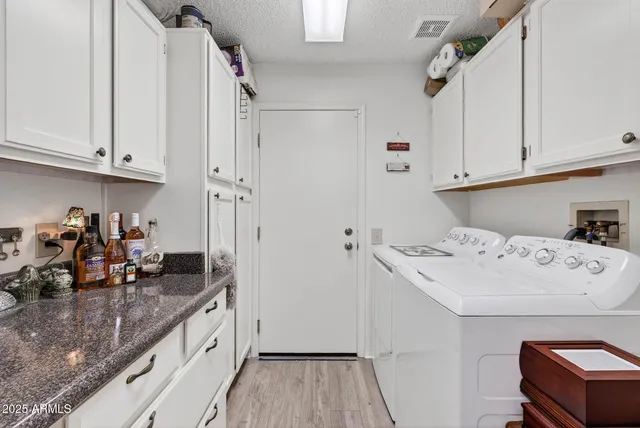 a view of a storage and utility room with a washer dryer