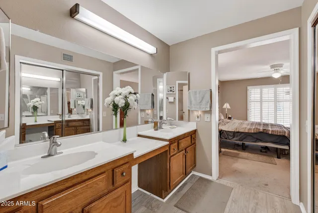 a en suite bathroom with double sink and a mirror