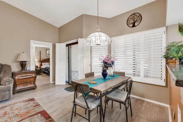 a view of a dining room with furniture and a chandelier