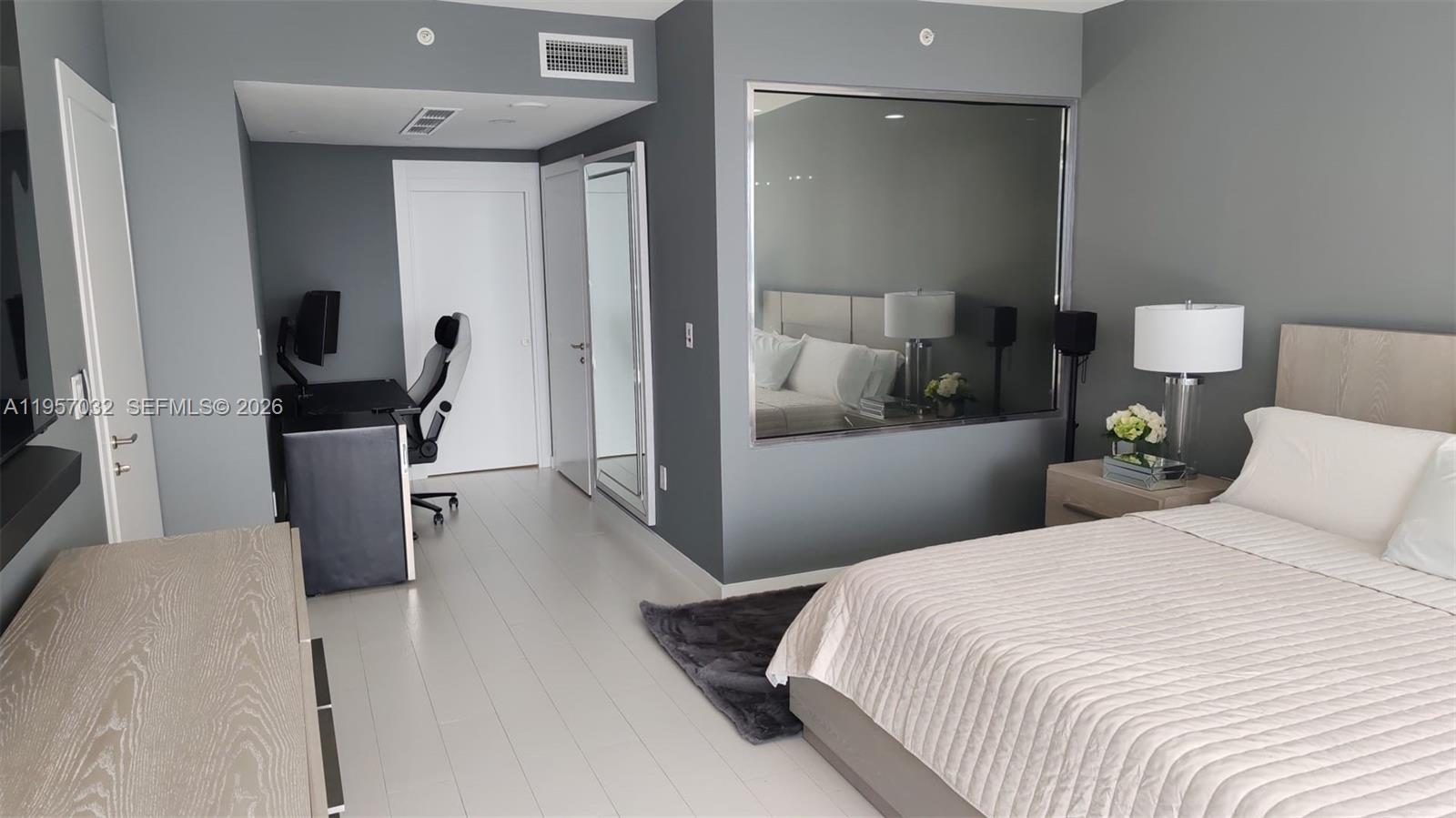 200 Biscayne Blvd Way, Unit 3907 Miami, FL 33131 - Photo 12 of 20 a bedroom with a bed and wooden floor