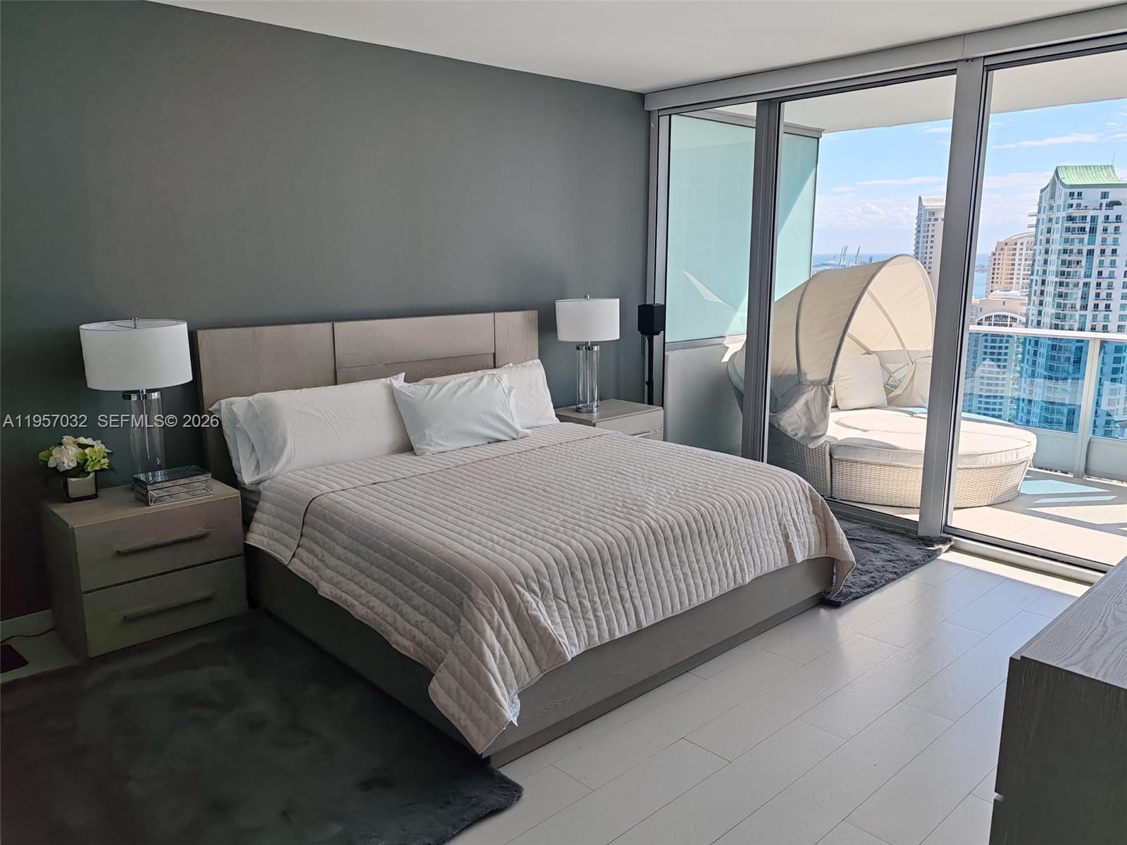 200 Biscayne Blvd Way, Unit 3907 Miami, FL 33131 - Photo 13 of 20 a bedroom with a bed and a large window