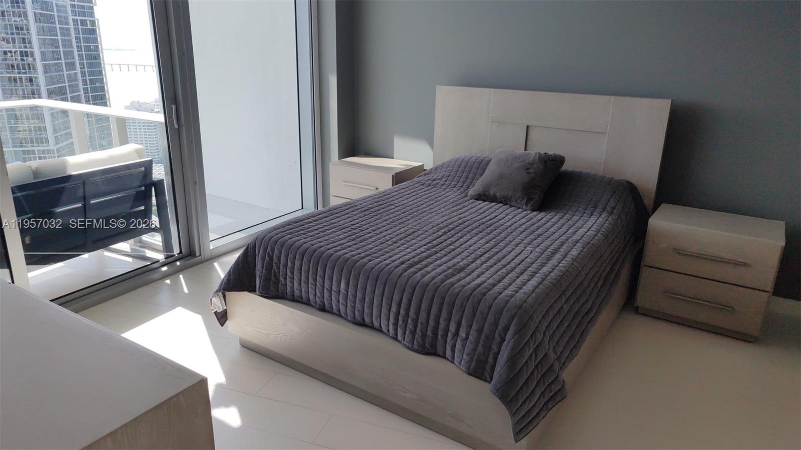 200 Biscayne Blvd Way, Unit 3907 Miami, FL 33131 - Photo 16 of 20 a bedroom with a bed and a window