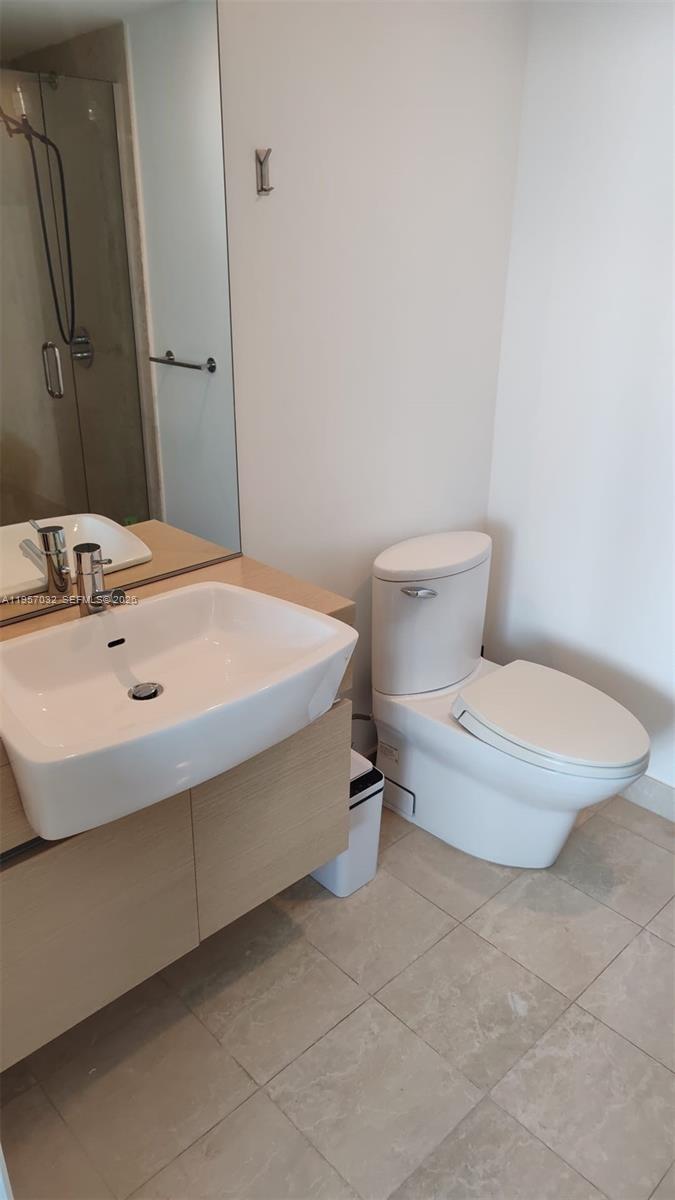 200 Biscayne Blvd Way, Unit 3907 Miami, FL 33131 - Photo 18 of 20 a bathroom with a sink and a toilet