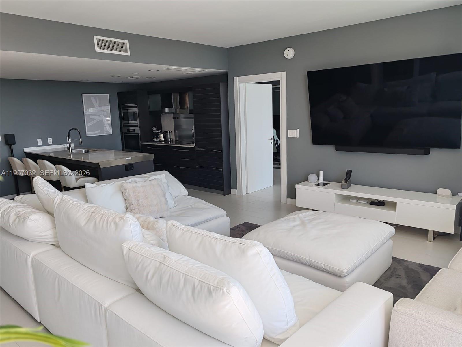 200 Biscayne Blvd Way, Unit 3907 Miami, FL 33131 - Photo 4 of 20 a living room with furniture and a flat screen tv