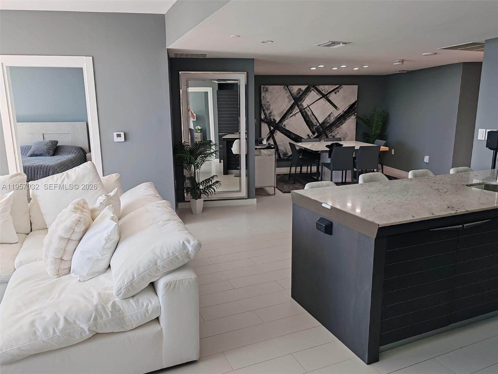 200 Biscayne Blvd Way, Unit 3907 Miami, FL 33131 - Photo 5 of 20 a bedroom with a bed and a mirror