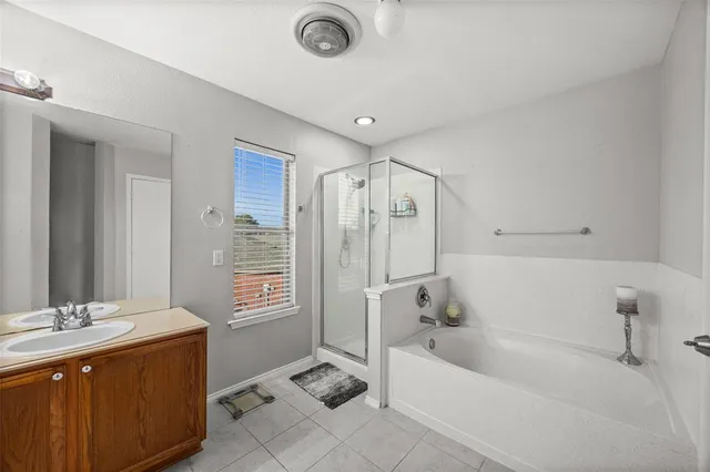 a bathroom with a tub sink and mirror
