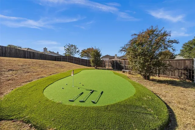 a view of a swimming pool with a yard and outdoor seating