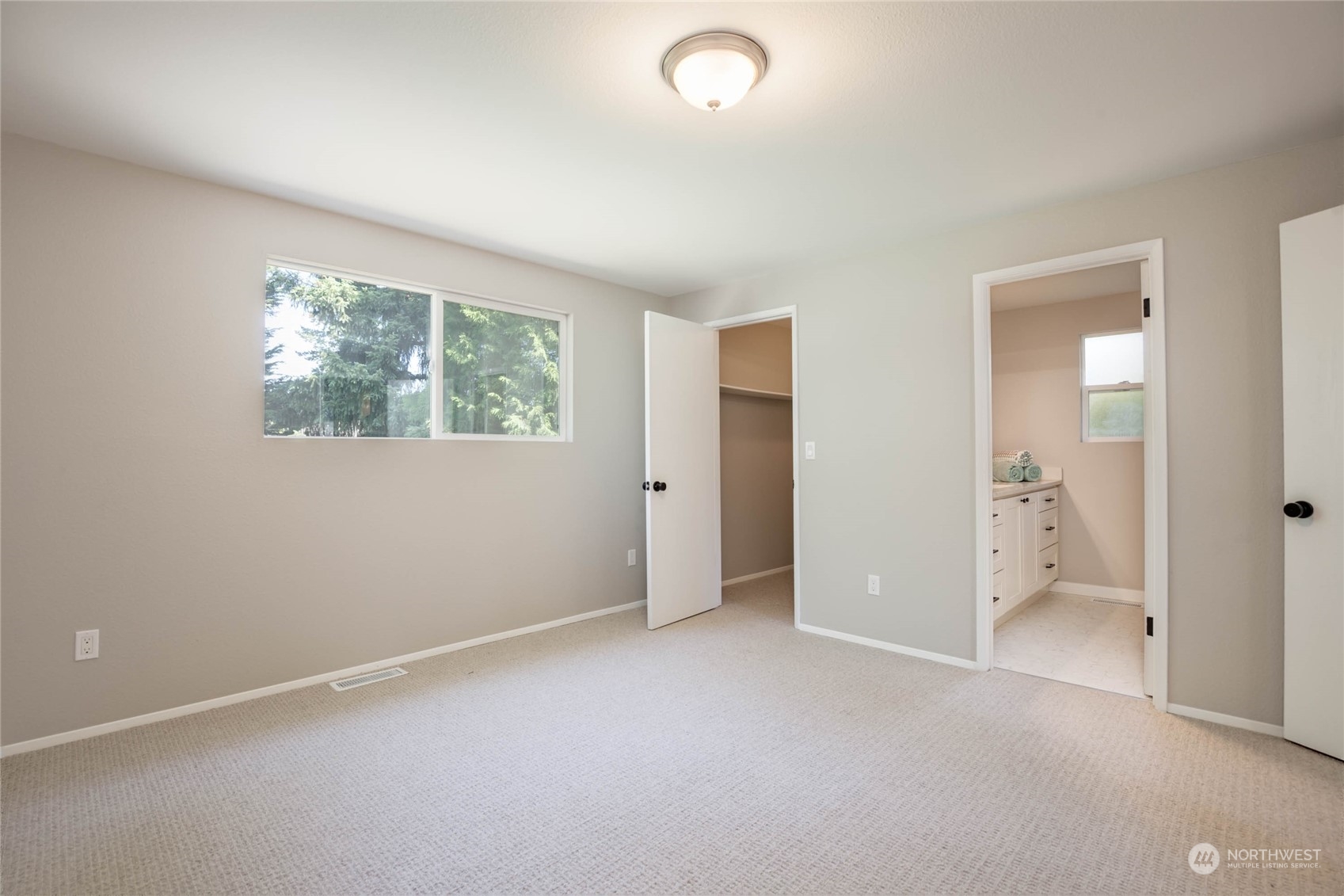 4216 Northeast 20th Street Renton, WA 98059 - Photo 11 of 26 an empty room with windows and closet