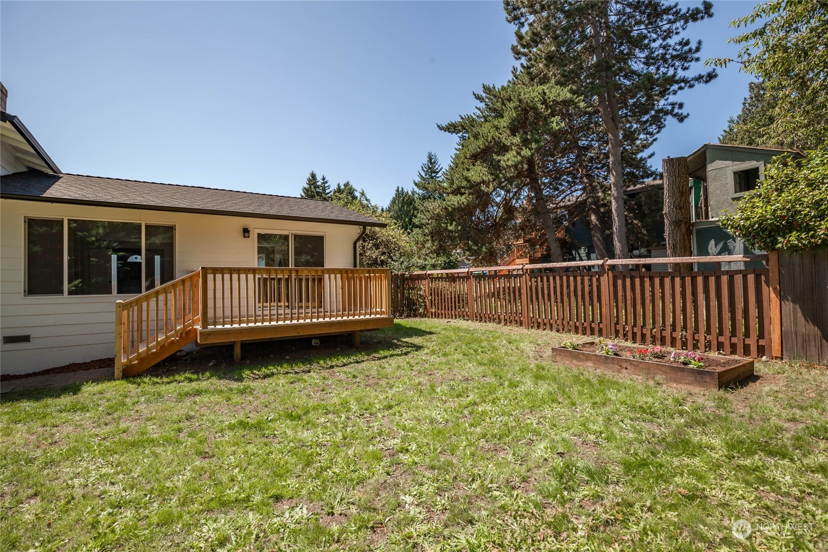 4216 Northeast 20th Street Renton, WA 98059 - Photo 22 of 26 a view of a house with a yard and deck