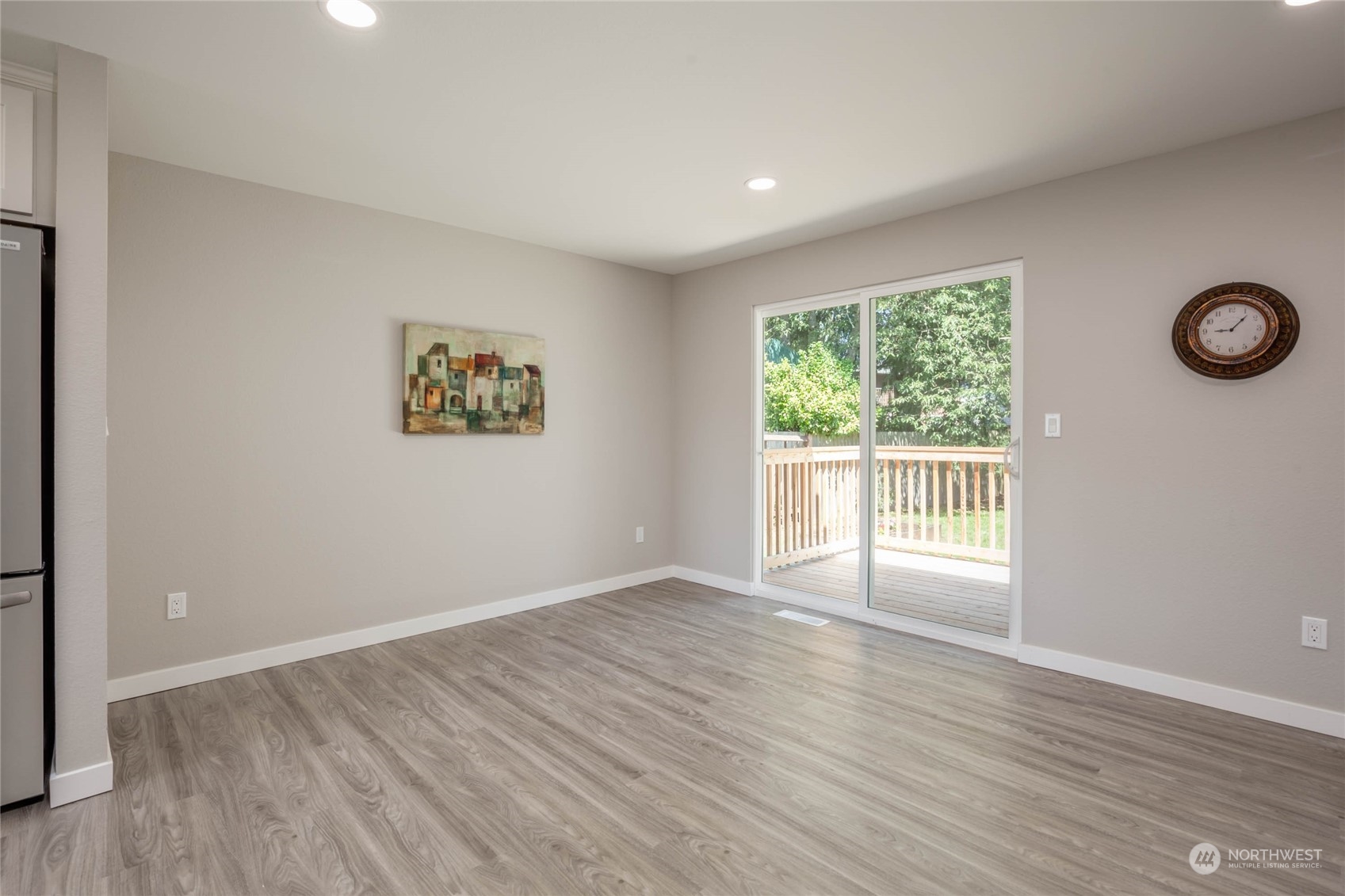 4216 Northeast 20th Street Renton, WA 98059 - Photo 5 of 26 an empty room with wooden floor and windows