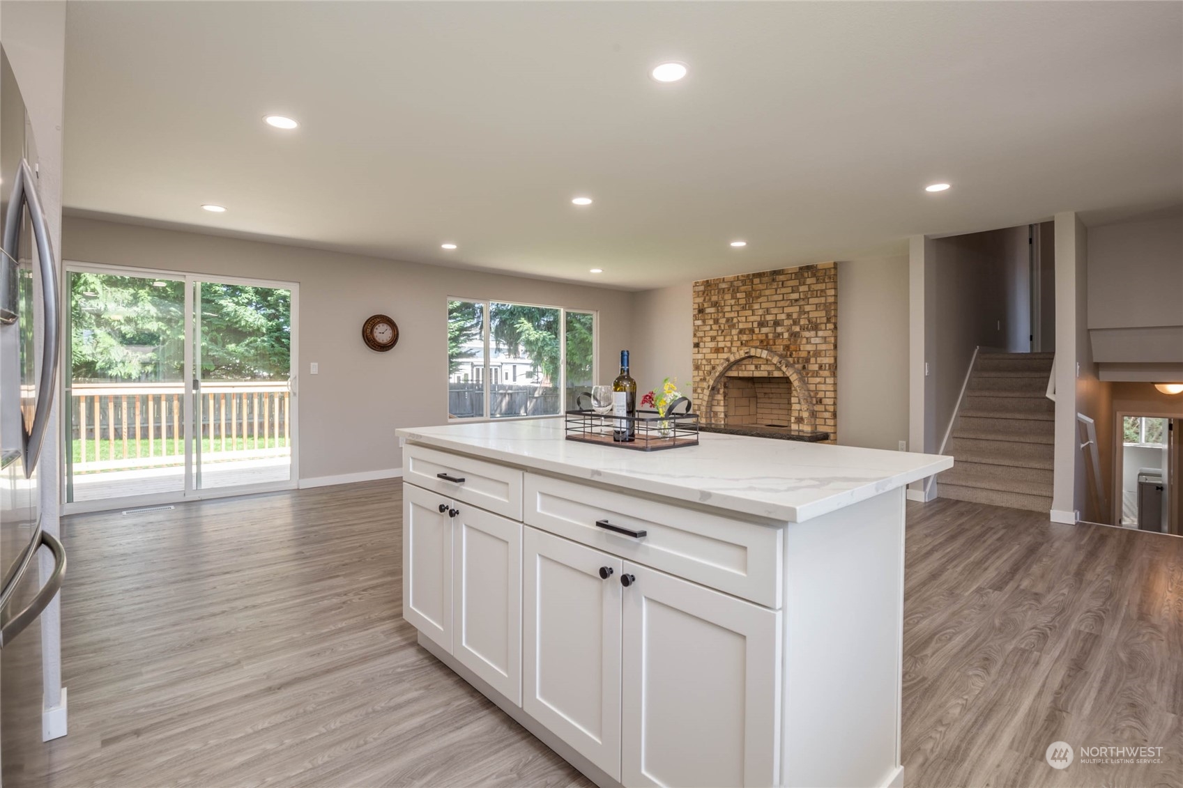 4216 Northeast 20th Street Renton, WA 98059 - Photo 7 of 26 a kitchen with stainless steel appliances granite countertop a sink stove and wooden floor