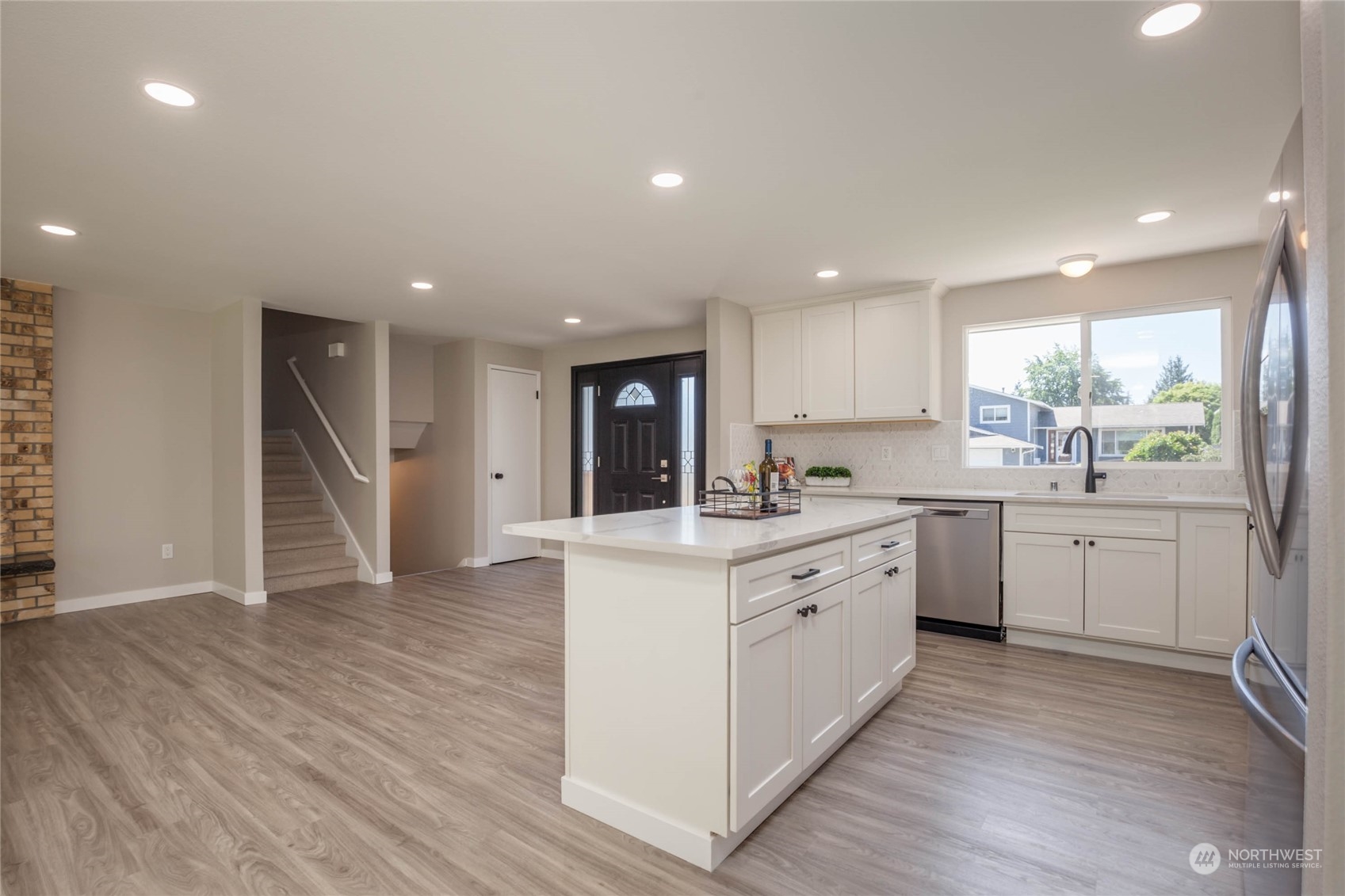 4216 Northeast 20th Street Renton, WA 98059 - Photo 8 of 26 a kitchen with a white wooden cabinets and white stainless steel appliances