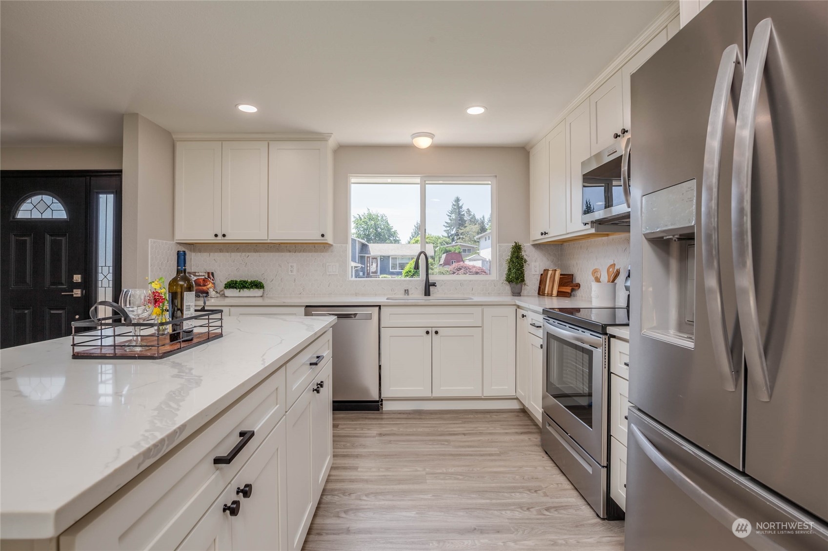 4216 Northeast 20th Street Renton, WA 98059 - Photo 9 of 26 a kitchen with stainless steel appliances granite countertop a sink stove and refrigerator
