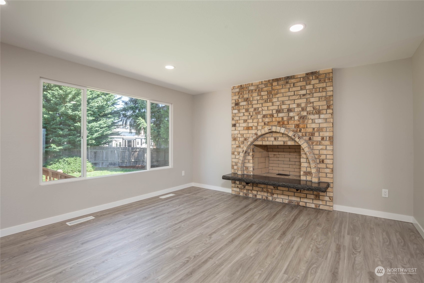 4216 Northeast 20th Street Renton, WA 98059 - Photo 10 of 26 an empty room with wooden floor and windows