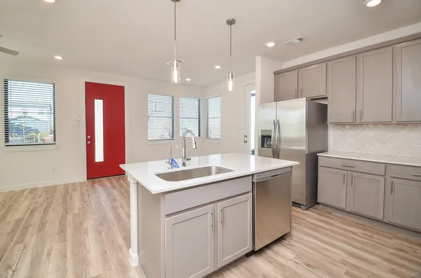 a kitchen with stainless steel appliances granite countertop a stove and a microwave