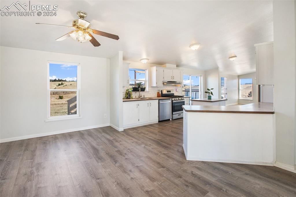 69 Aspen Drive Divide, CO 80814 - Photo 12 of 50 a view of a kitchen with microwave and wooden floor
