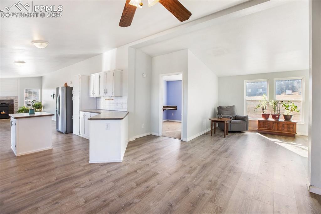 69 Aspen Drive Divide, CO 80814 - Photo 14 of 50 a view of a living room and kitchen with furniture wooden floor and windows