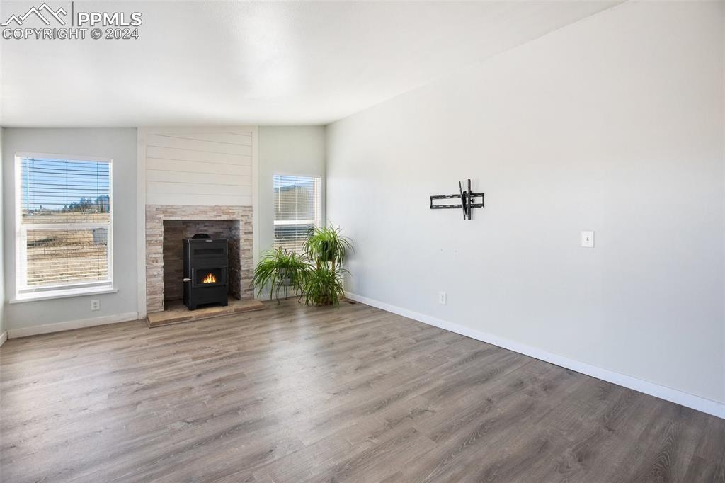 69 Aspen Drive Divide, CO 80814 - Photo 6 of 50 an empty room with wooden floor and a fireplace