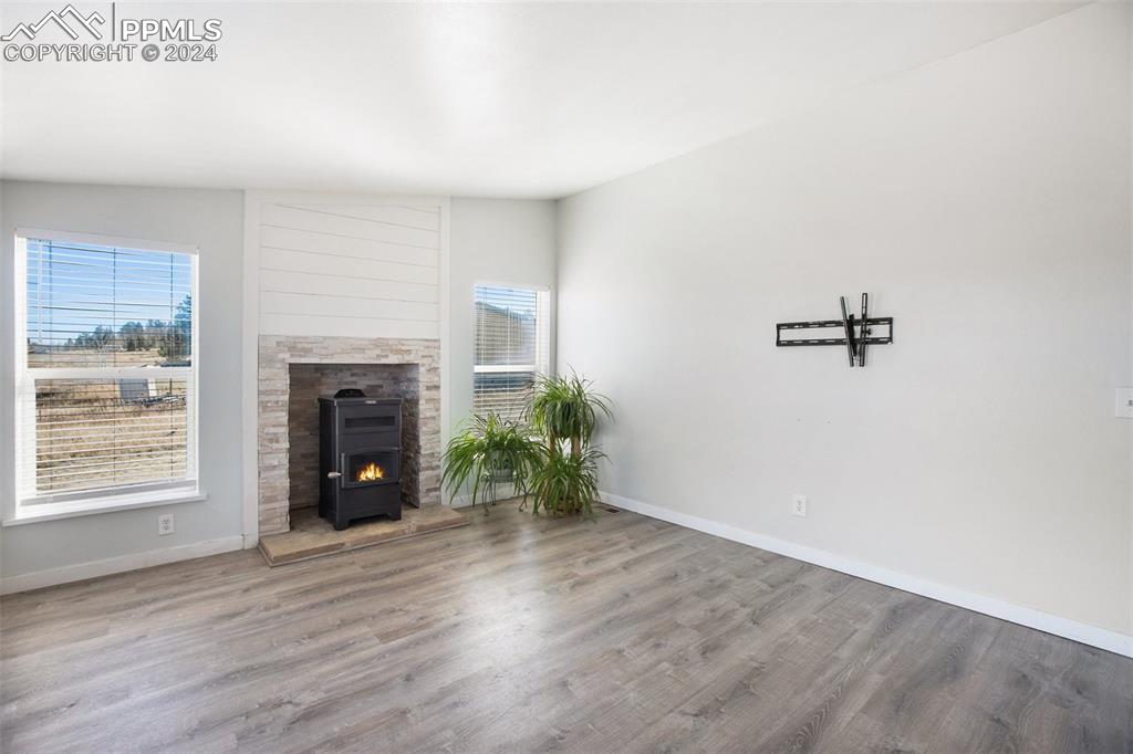 69 Aspen Drive Divide, CO 80814 - Photo 8 of 50 a view of an empty room with a fireplace and a window
