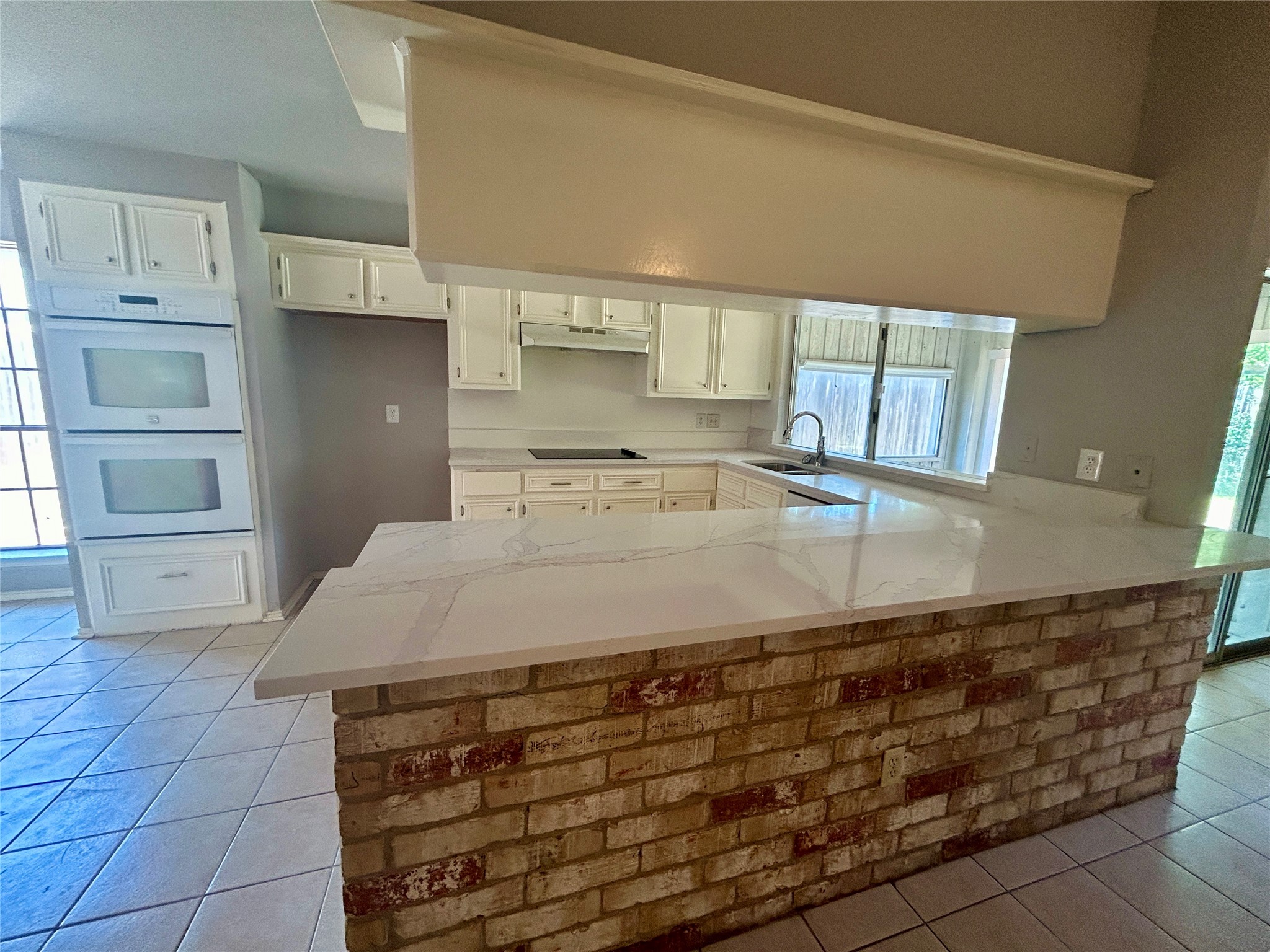 2510 Knollbrook Lane Spring, TX 77373 - Photo 11 of 24 a kitchen with kitchen island sink and cabinets