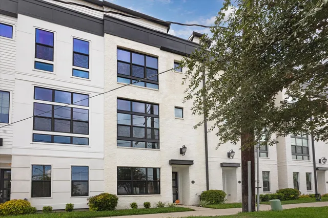 a front view of a building with a garden