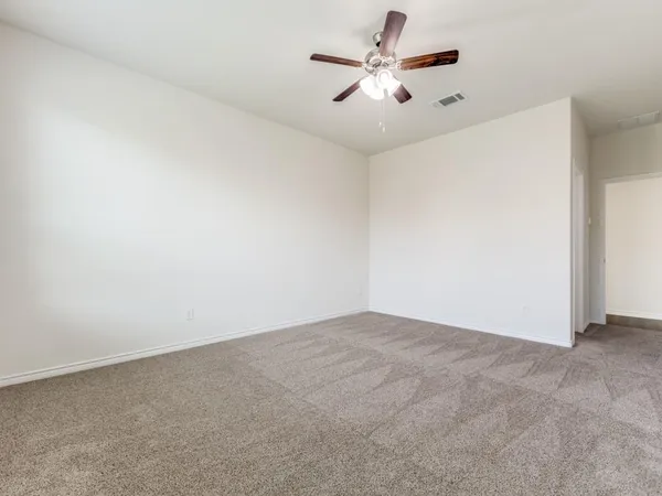 an empty room with a empty space and a ceiling fan