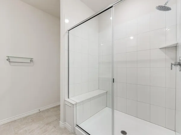 a spacious bathroom with double sink and a mirror