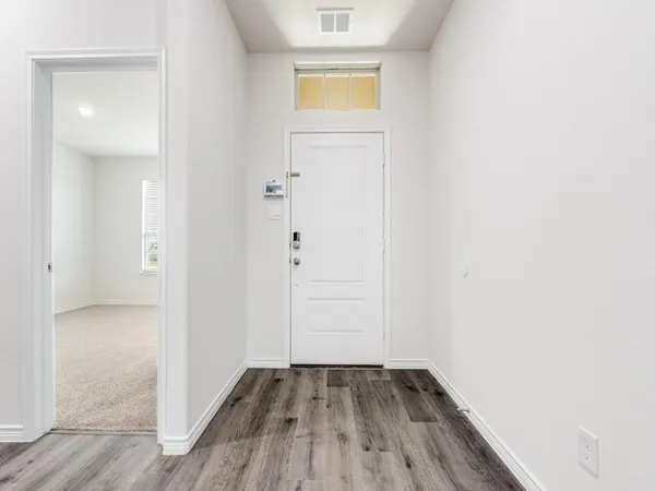an empty room with wooden floor and closet
