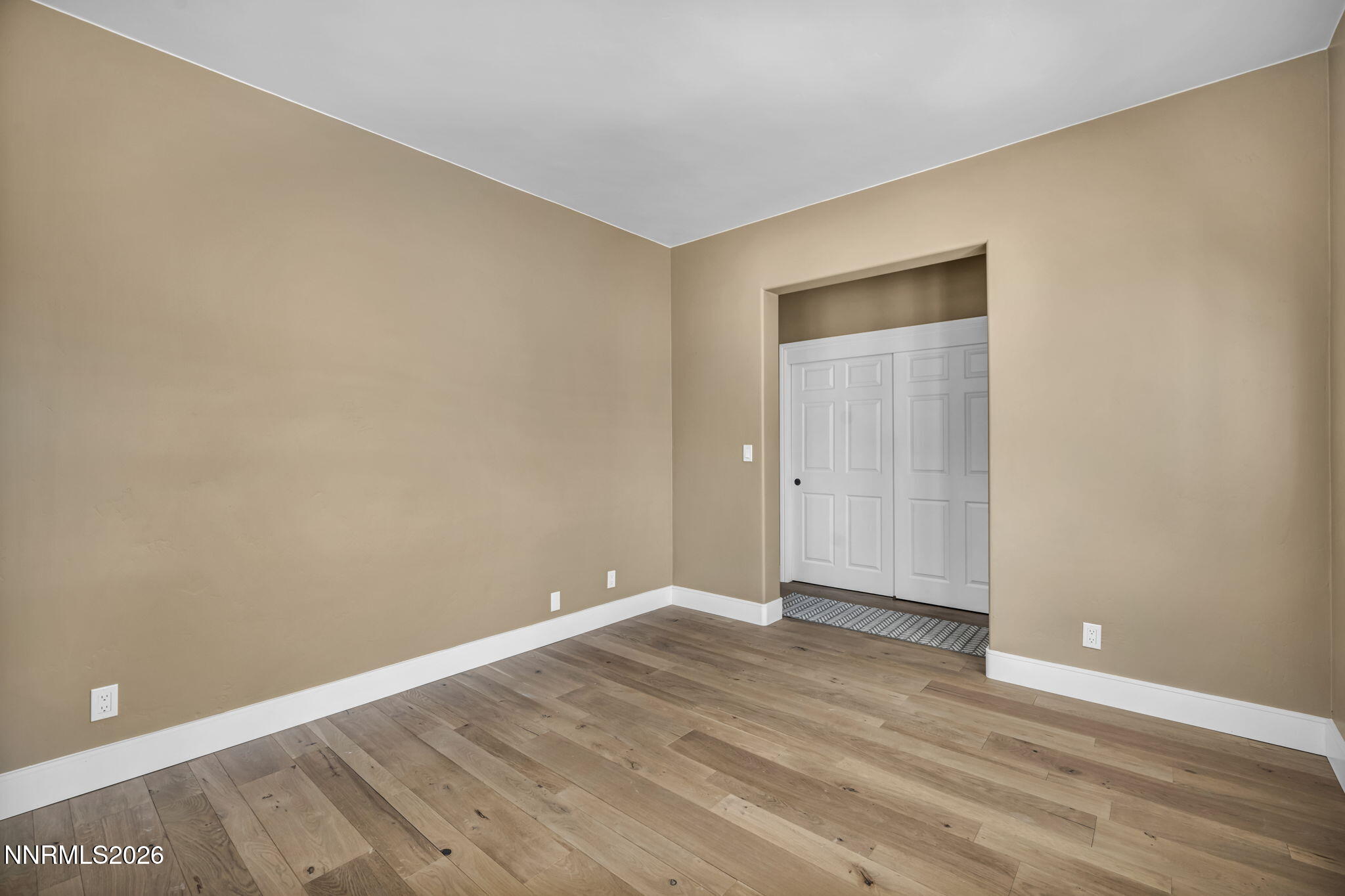 2965 Roundrock Court Reno, NV 89511 - Photo 16 of 40 a view of an empty room with wooden floor and closet
