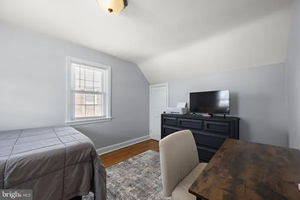a bedroom with furniture and a flat screen tv