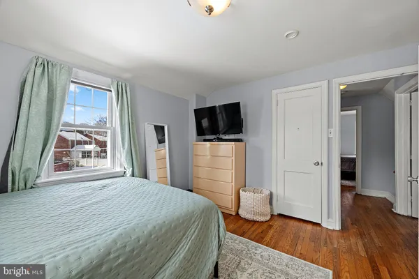 a bedroom with a bed and a television