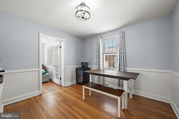 a view of a room with wooden floor and windows
