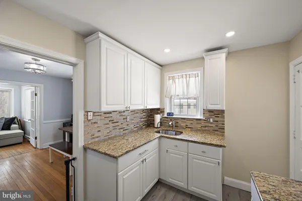 a kitchen with a sink stove and cabinets
