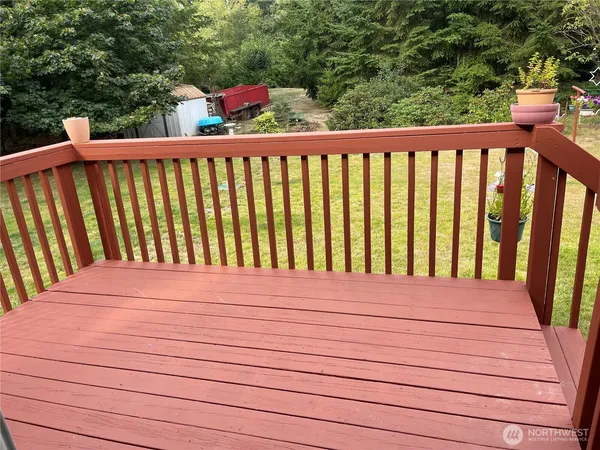 a view of a field of grass and trees