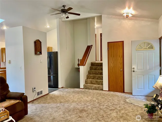 a bathroom with a granite countertop sink a toilet and a mirror