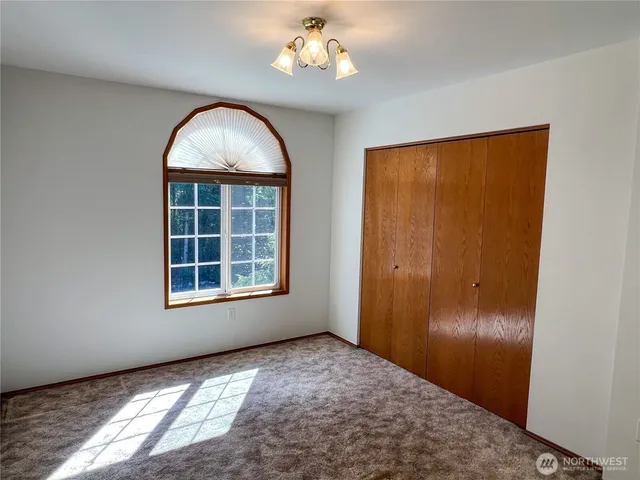 a view of a patio with table and chairs under an umbrella