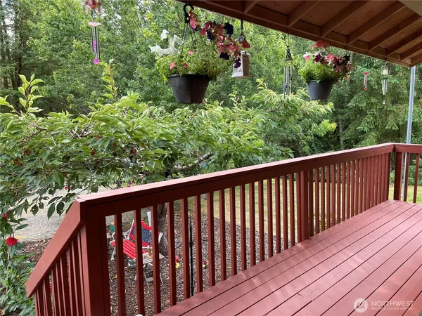 a balcony with wooden floor and outdoor space
