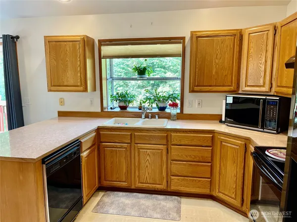 a kitchen with a sink stove and microwave