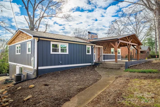 a view of a house with a yard covered in snow
