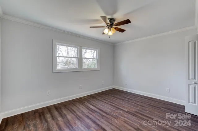 a view of a room with wooden floor and windows