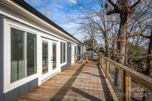 a view of balcony with wooden floor and fence